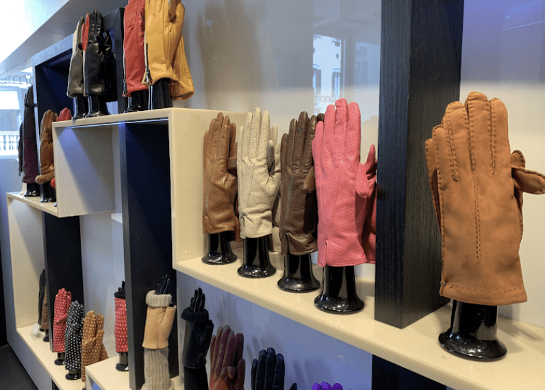 Colorful gloves on a shelf.